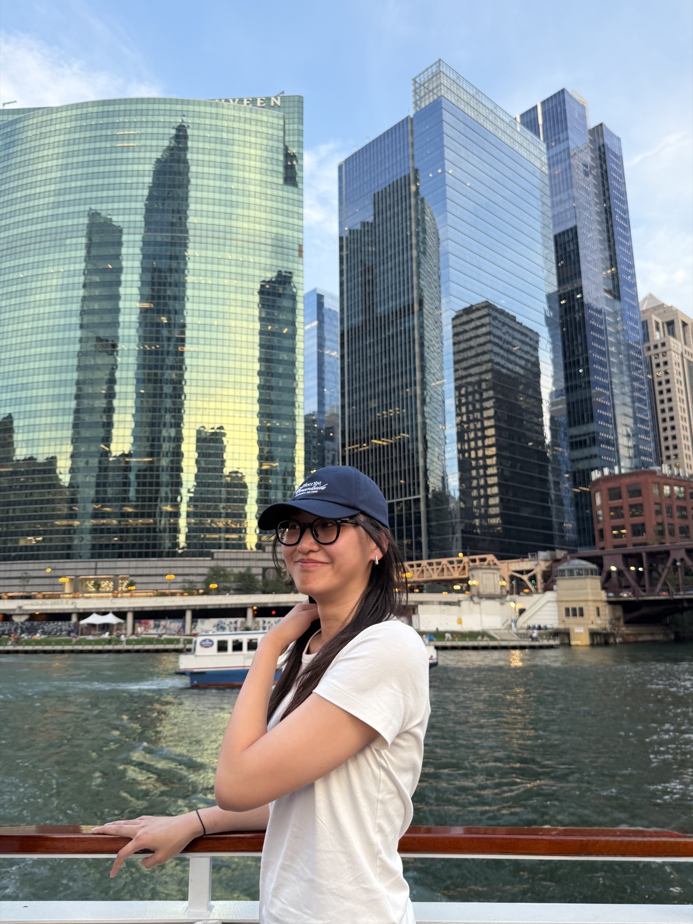 Yiwen on a boat with Chicago's riverfront skyline behind her